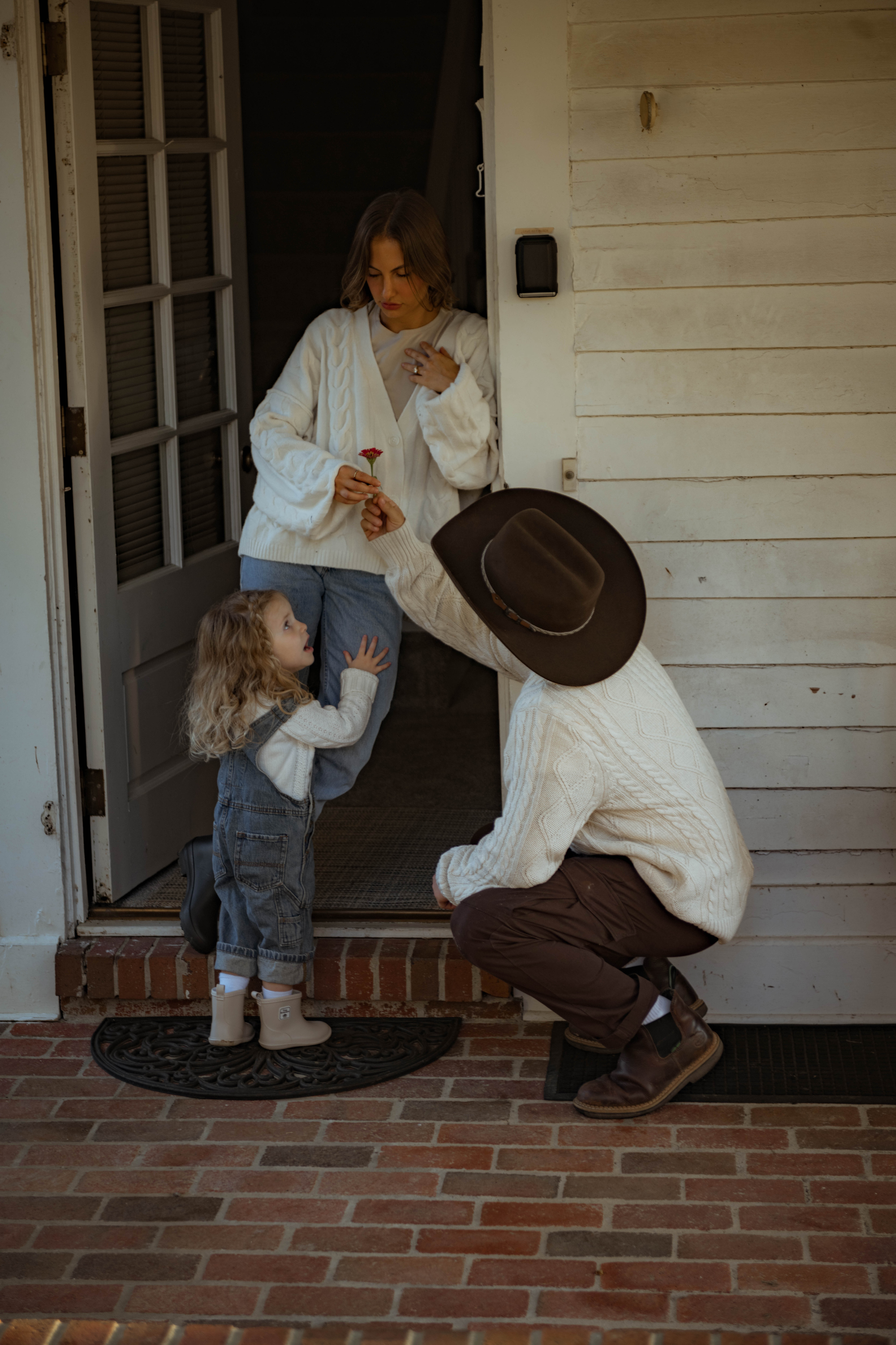 family in doorway of home
